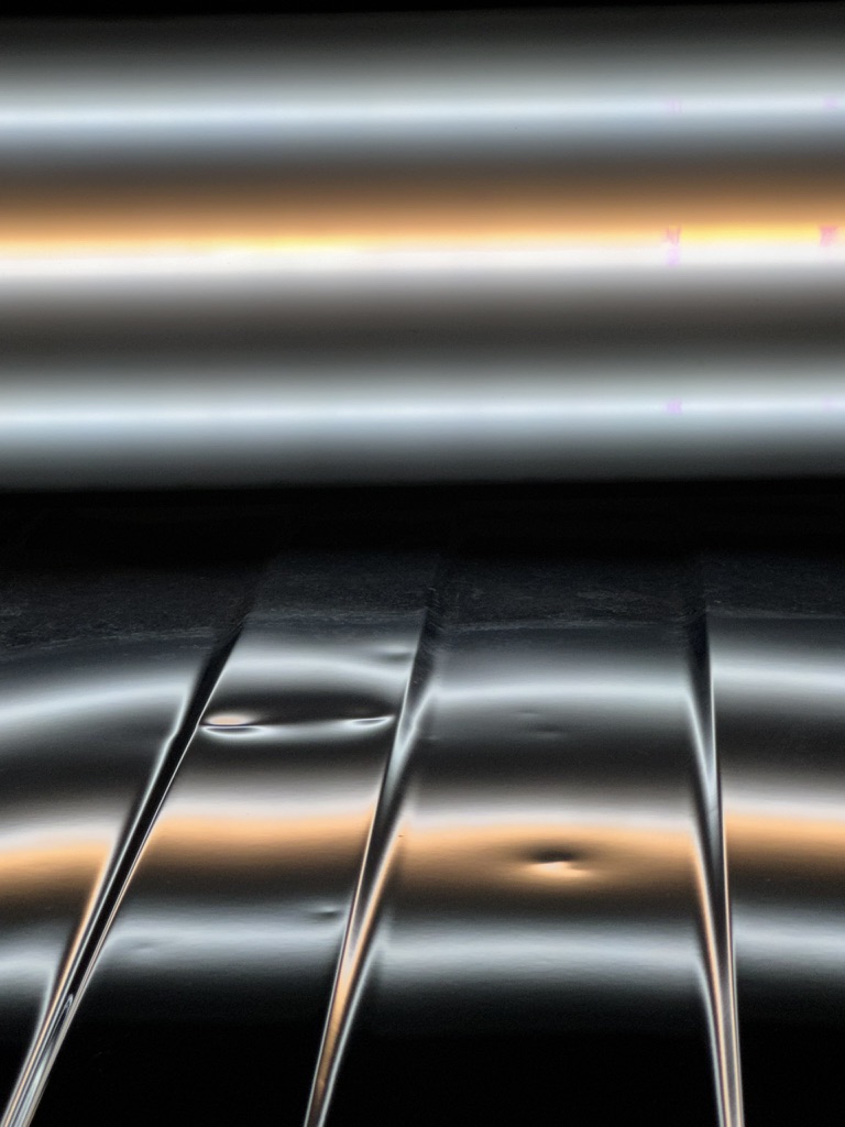 Multiple small roof dents highlighted by PDR reflection lines